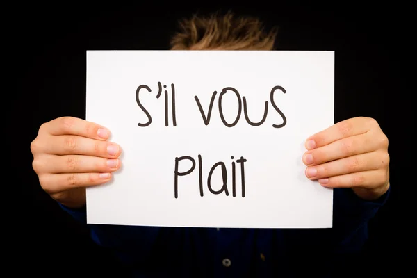 Παιδί κρατάει πινακίδα με Γαλλικές λέξεις Σ il Vous κοτσίδα - παρακαλώ — Φωτογραφία Αρχείου
