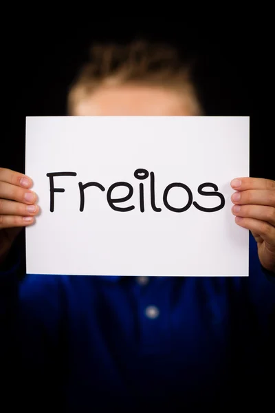 Child holding sign with German word Freilos - See You Later