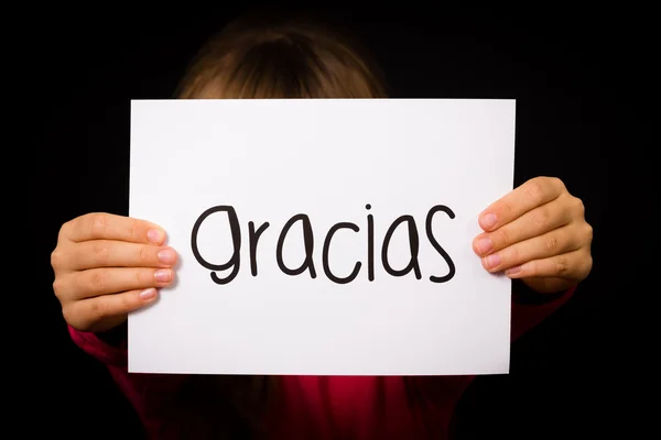 Child holding sign with Spanish word Gracias - Thank You — Stock Photo, Image