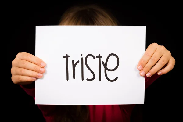 Child holding sign with Spanish word Triste - Sorry — Stock Photo, Image