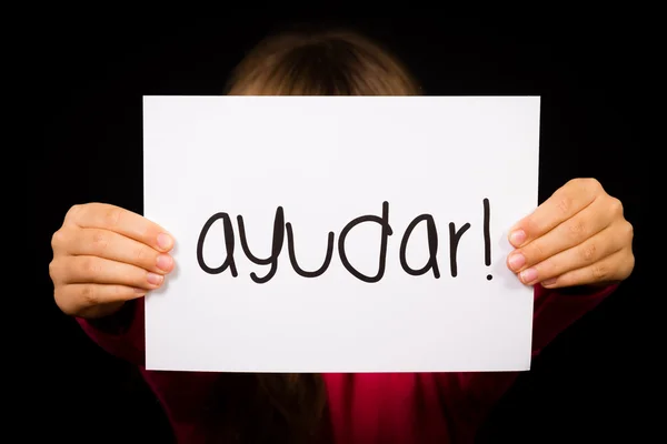 Child holding sign with Spanish word Ayudar - Help — Stock Photo, Image