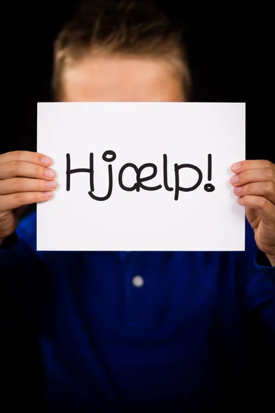 Child holding sign with Danish word Hjaelp - Help — Stock Photo, Image