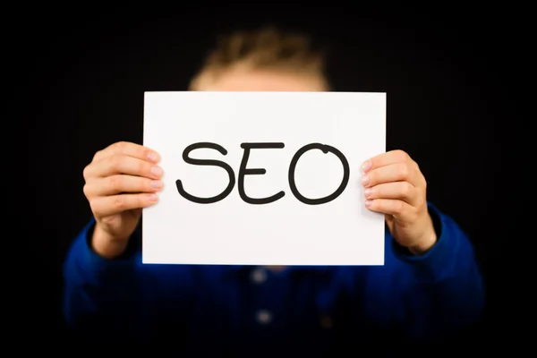 Person holding SEO sign — Stock Photo, Image