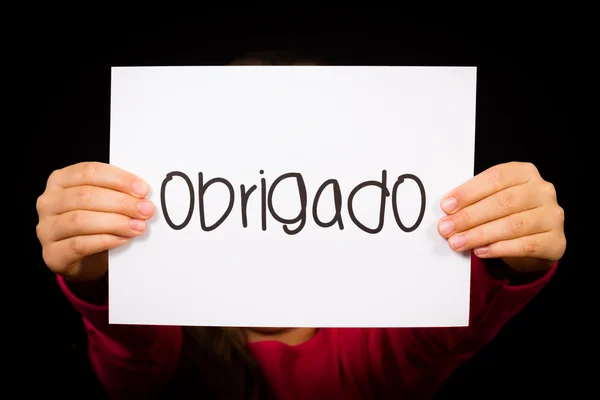 Barn med skylt med portugisiska ordet Obrigado - tack — Stockfoto