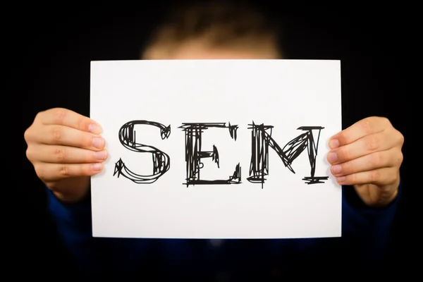 Male holding SEM sign — Stock Photo, Image