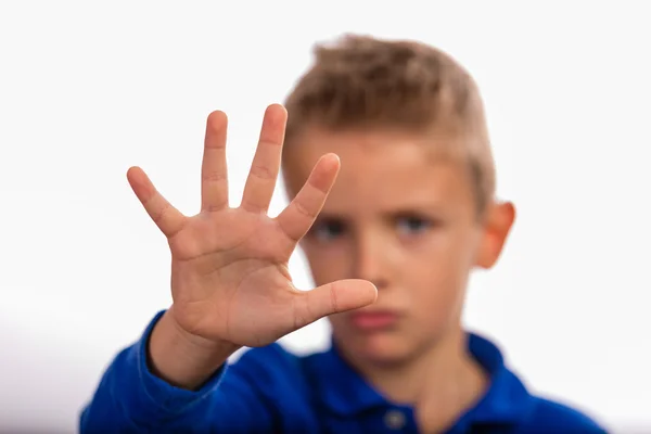 Boy making a stop gesture with his hand — Stock Photo, Image