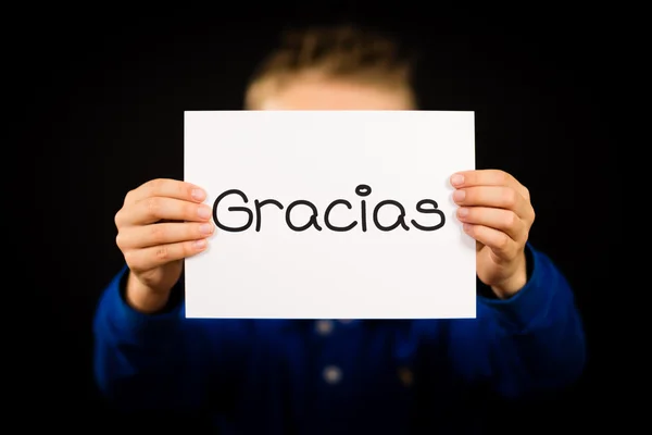 Child holding sign with Spanish word Gracias - Thank You — Stock Photo, Image