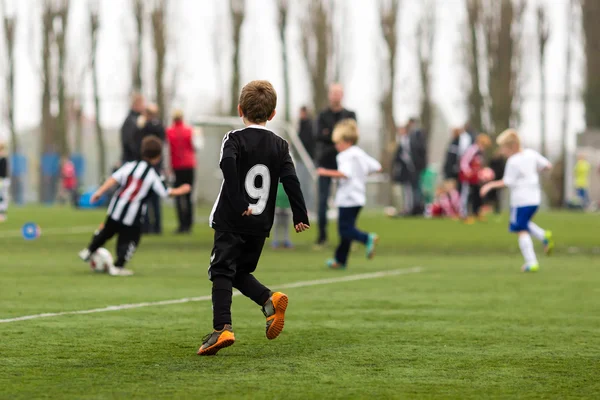 Two teams of boys playing soccer — Stock Photo, Image