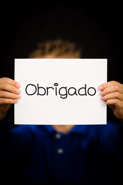 Child holding sign with Portuguese word Obrigado - Thank You — Stock Photo, Image