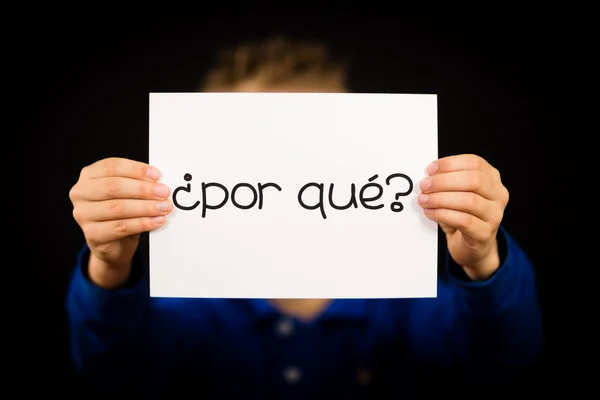 Child holding sign with Spanish words Por Que - Why — Stock Photo, Image