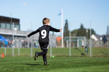 Young boy during soccer match clipart
