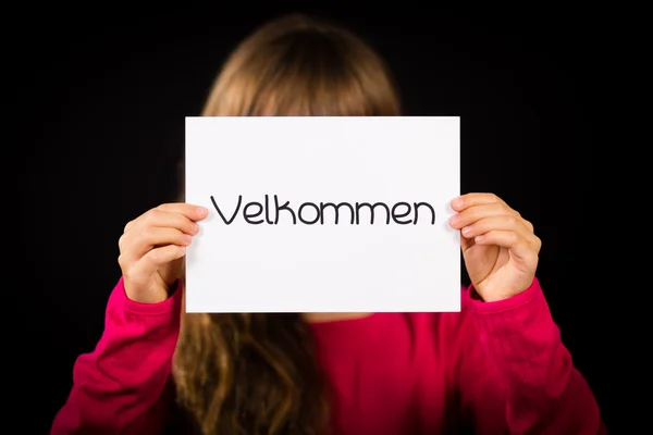 Child holding sign with Danish word Velkommen - Welcome — Stock Photo, Image