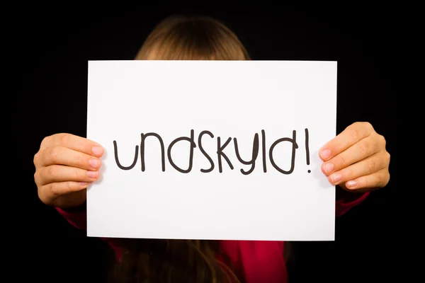 Child holding sign with Danish word Undskyld - Sorry — Stock Photo, Image