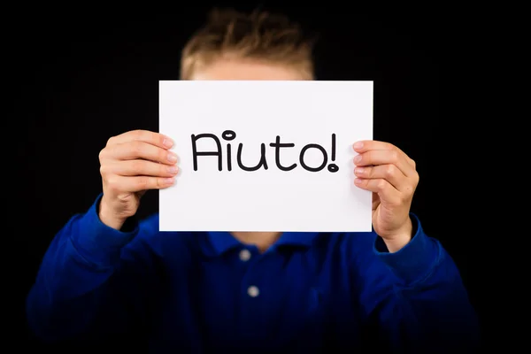Signe d'exploitation d'enfant avec le mot italien Aiuto - Aide — Photo