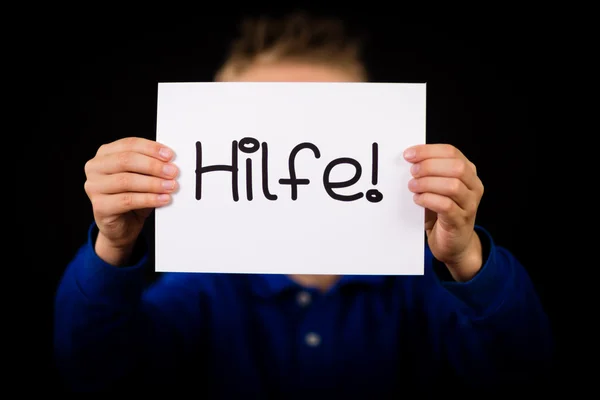 Child holding sign with German word Hilfe - Help — Stock Photo, Image