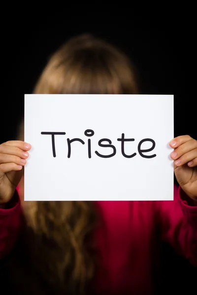 Child holding sign with Spanish word Triste - Sorry — Stock Photo, Image
