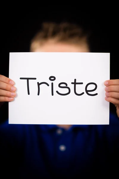 Child holding sign with Spanish word Triste - Sorry — Stock Photo, Image