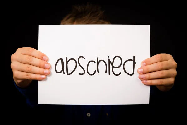 Child holding sign with German word Abschied - Goodbye — Stock Photo, Image
