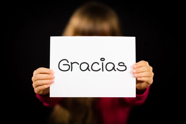 Дитина тримає знак з іспанське слово Gracias - дякую вам — стокове фото