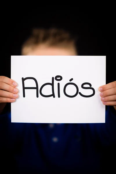 Dítě drží ceduli s španělské slovo Adios - Sbohem — Stock fotografie