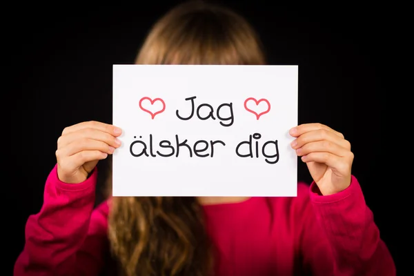 孩子举牌子以瑞典语词语 Jag Alsker 挖-我爱 Yo — 图库照片
