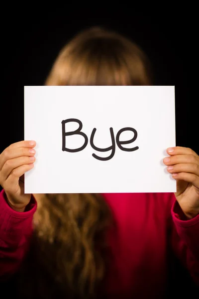 Dziecko trzyma znak z hiszpańskie słowo Bye, co oznacza, można zobaczyć Lat — Zdjęcie stockowe