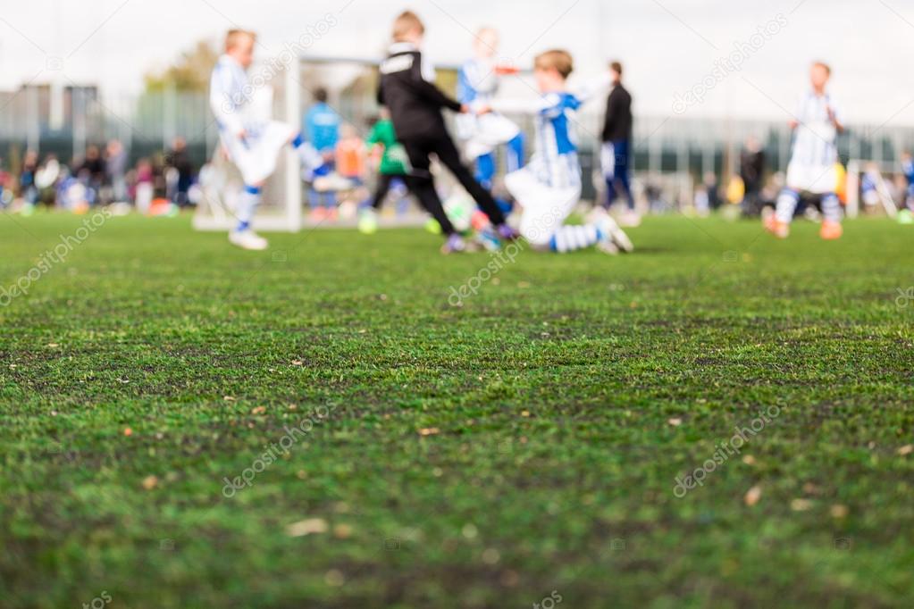 Blurred young kids playing soccer