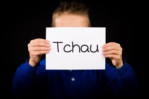 Dítě drží ceduli s portugalské slovo Tchau - uvidíme se později — Stock fotografie
