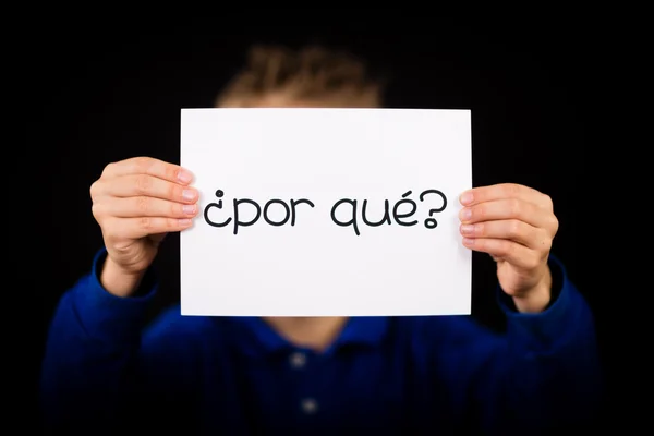 Barn med skylt med spanska ord Por Que - varför — Stockfoto