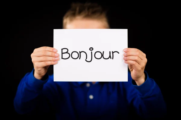 Το παιδί κρατάει πινακίδα με γαλλική λέξη Bonjour - γειά σου — Φωτογραφία Αρχείου