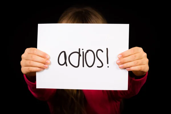 Το παιδί κρατάει πινακίδα με ισπανική λέξη Adios - αντίο — Φωτογραφία Αρχείου