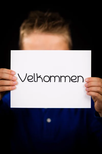 Child holding sign with Danish word Velkommen - Welcome — Stock Photo, Image