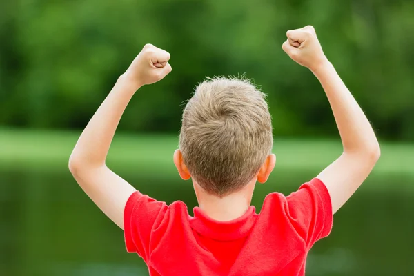 Back of child with fists in the air — Stock Photo, Image