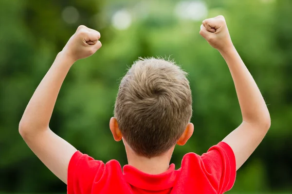 Child with raised fists — Stock Photo, Image