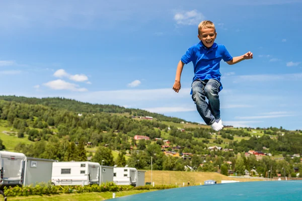 Young boy jumping on trampoline — Stock Photo, Image