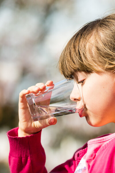 Girl drinking water from glass