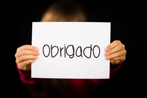 Child holding sign with Portuguese word Obrigado - Thank You — Stock Photo, Image