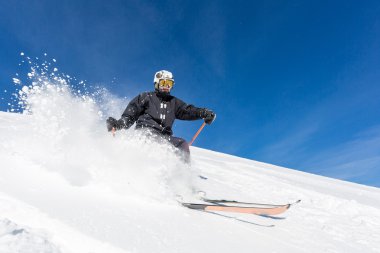 Male skier skiing at ski resort clipart
