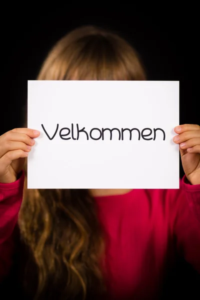 Child holding sign with Danish word Velkommen - Welcome — Stock Photo, Image