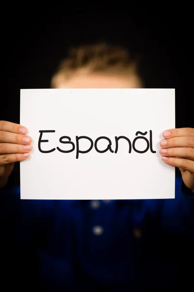 Criança segurando sinal com a palavra espanhola Espanol - Espanhol em Englis — Fotografia de Stock