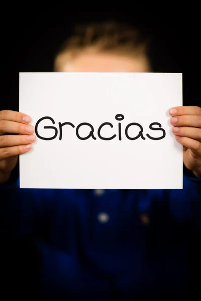 Child holding sign with Spanish word Gracias - Thank You — Stock Photo, Image
