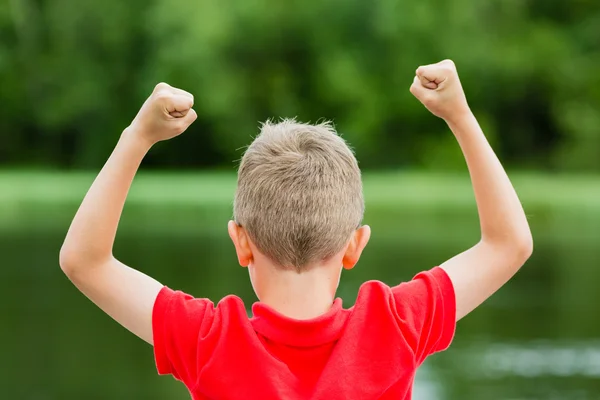 Back of child with fists in the air — Stock Photo, Image