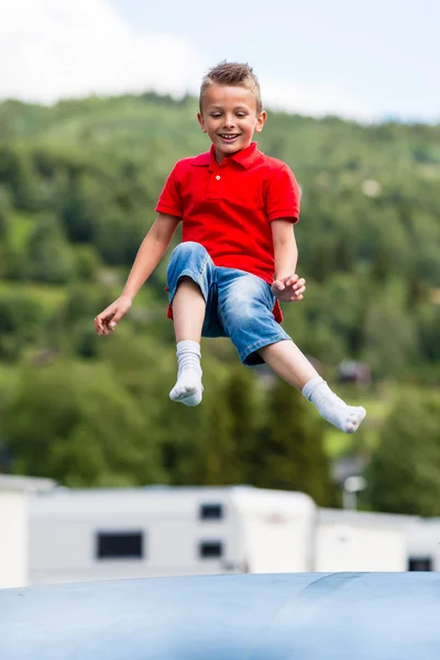 Child jumping on trampoline — Stock Photo, Image