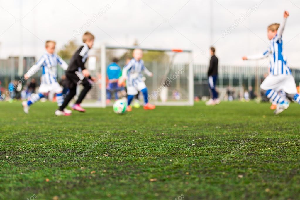 Blur of young boys playing soccer match