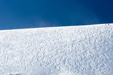 Off piste ski tracks on powder snow clipart