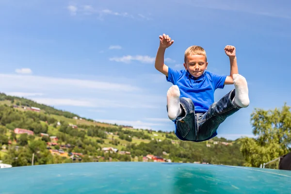 Young boy jumping on trampoline — Stock Photo, Image