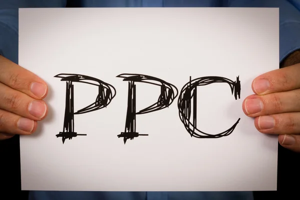 Person holding PPC sign — Stock Photo, Image