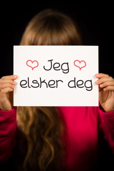 Dziecko trzyma znak z norweskim słowa Jeg Elsker Dig - kocham — Zdjęcie stockowe