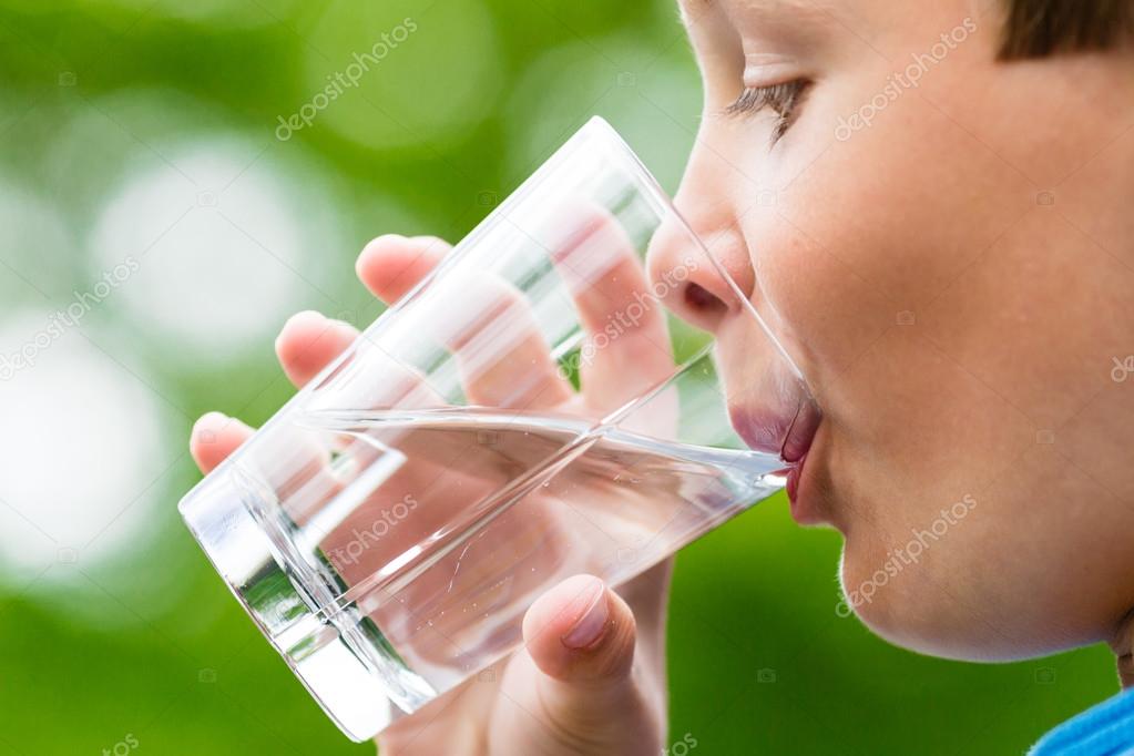 Boy drinking fresh water from glass