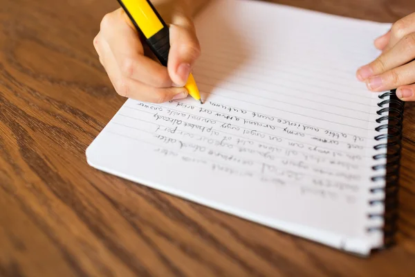 Chica escribiendo a mano en el bloc de notas — Foto de Stock